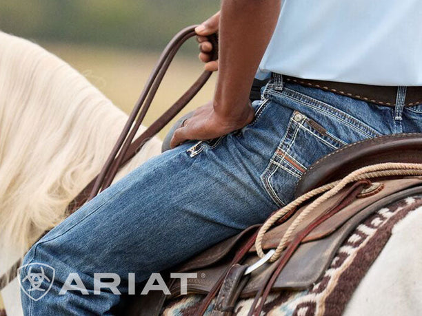Cowboy riding, wearing Ariat western denim