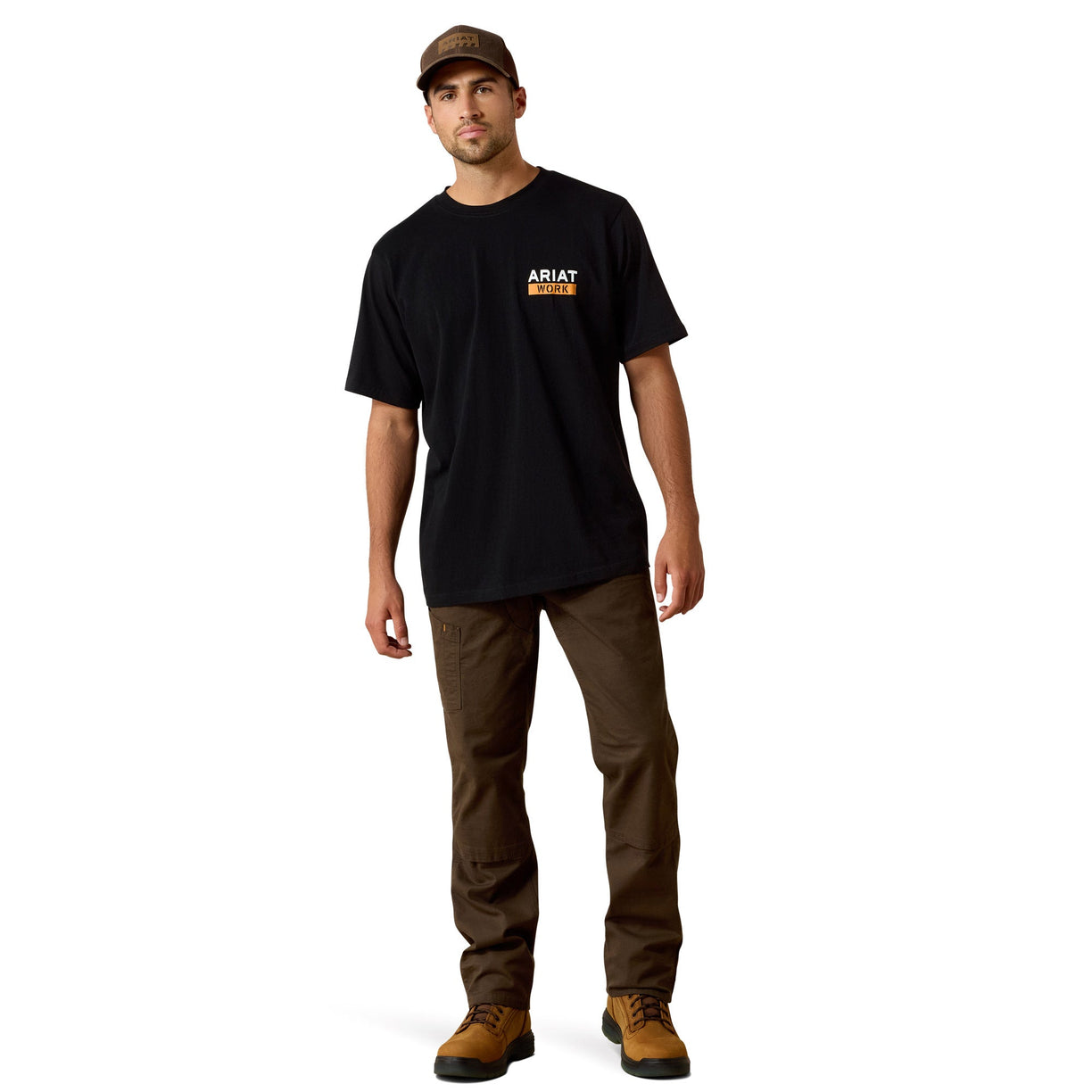 Man wearing a black t-shirt with a logo and brown pants on a white background