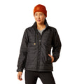 Person wearing a black jacket and orange beanie on a white background