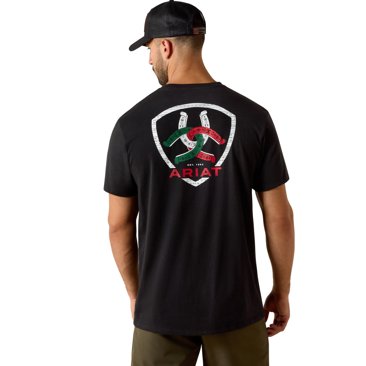 Man wearing a black t-shirt with a logo on the back, standing against a white background