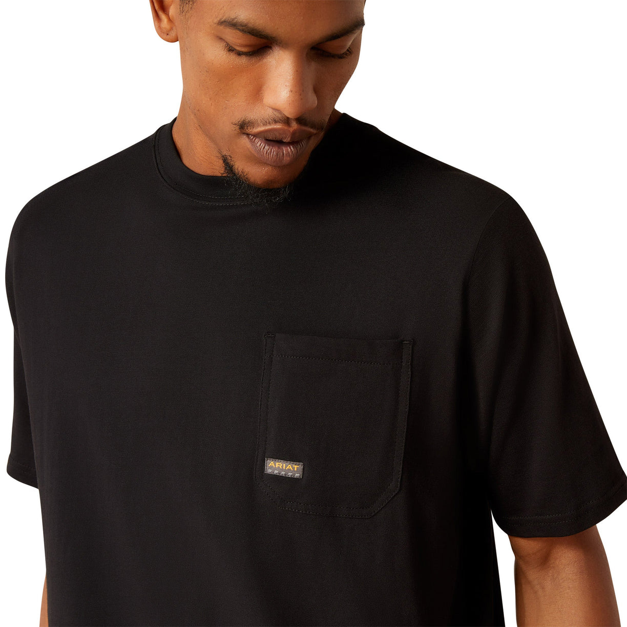 Person wearing a black t-shirt with a skull and hard hat graphic on the back.