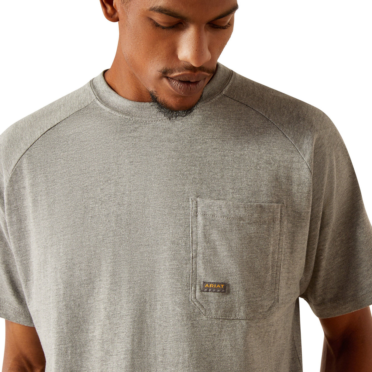 Person wearing a gray t-shirt with 'Ariat Workhogs' logo on the back