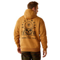 Man wearing a brown hoodie with Ariat Work branding and cap on a white background