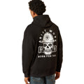 Person wearing a black hoodie with a skull and hard hat design on the back, on a white background.