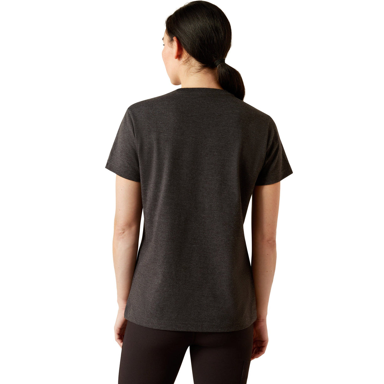 Person wearing a black t-shirt with 'Ariat' logo and text on a white background