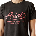 Person wearing a black t-shirt with 'Ariat' logo and text on a white background