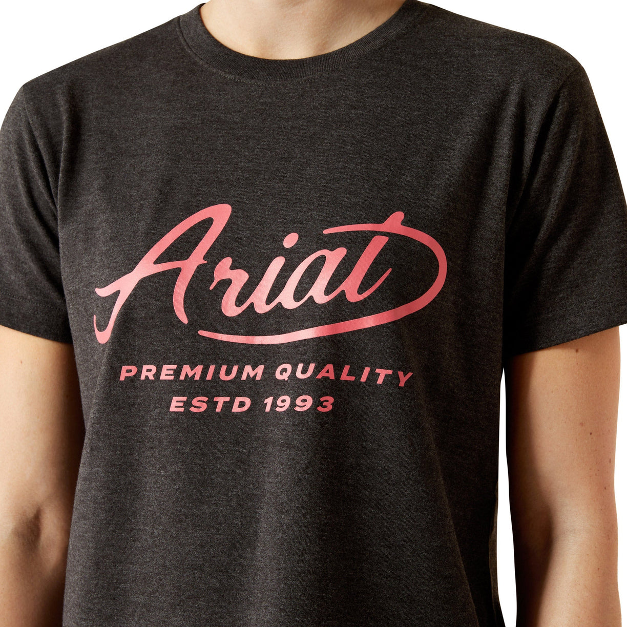 Person wearing a black t-shirt with 'Ariat' logo and text on a white background