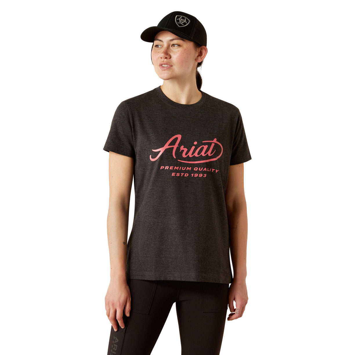Person wearing a black t-shirt with 'Ariat' logo and text on a white background