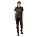 Person wearing a black t-shirt with 'Ariat' logo and text on a white background