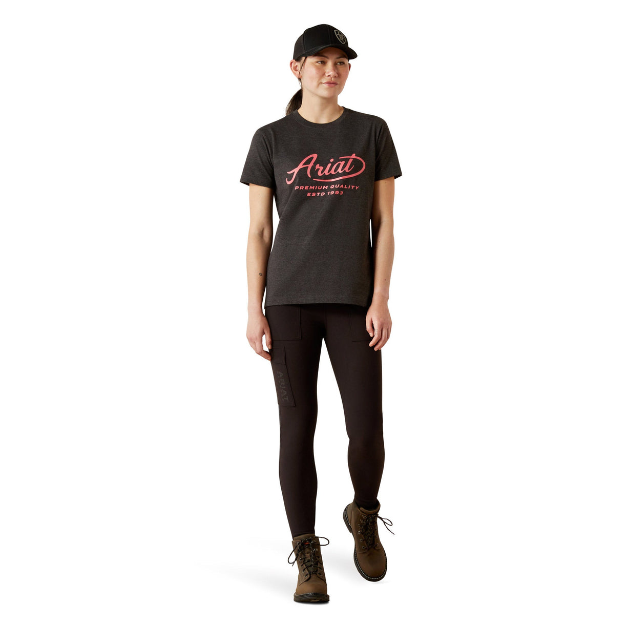 Person wearing a black t-shirt with 'Ariat' logo and text on a white background