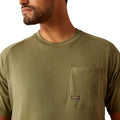 Man wearing a green t-shirt with a graphic design on the back, standing against a white background