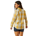 Woman wearing a yellow plaid shirt on a white background