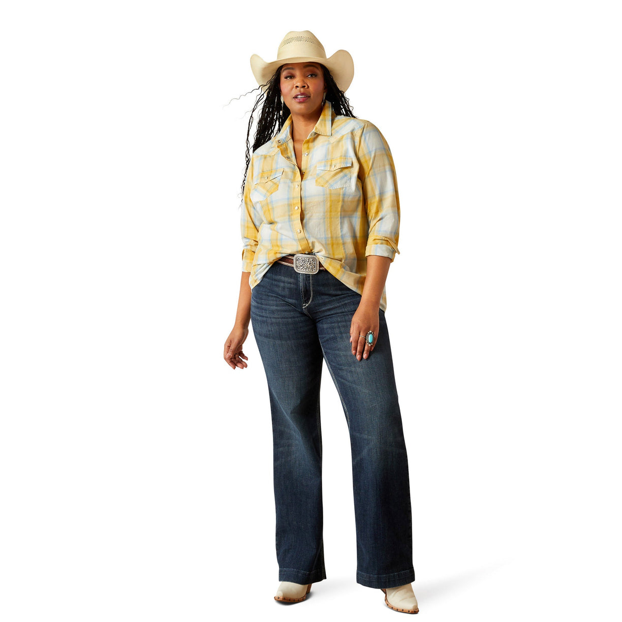 Woman wearing a yellow plaid shirt, blue jeans, and a cowboy hat on a white background