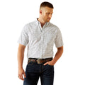 Man wearing a patterned shirt and jeans on a white background