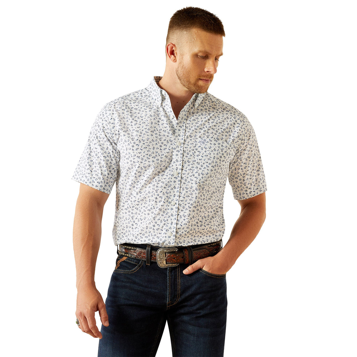 Man wearing a patterned shirt and jeans on a white background