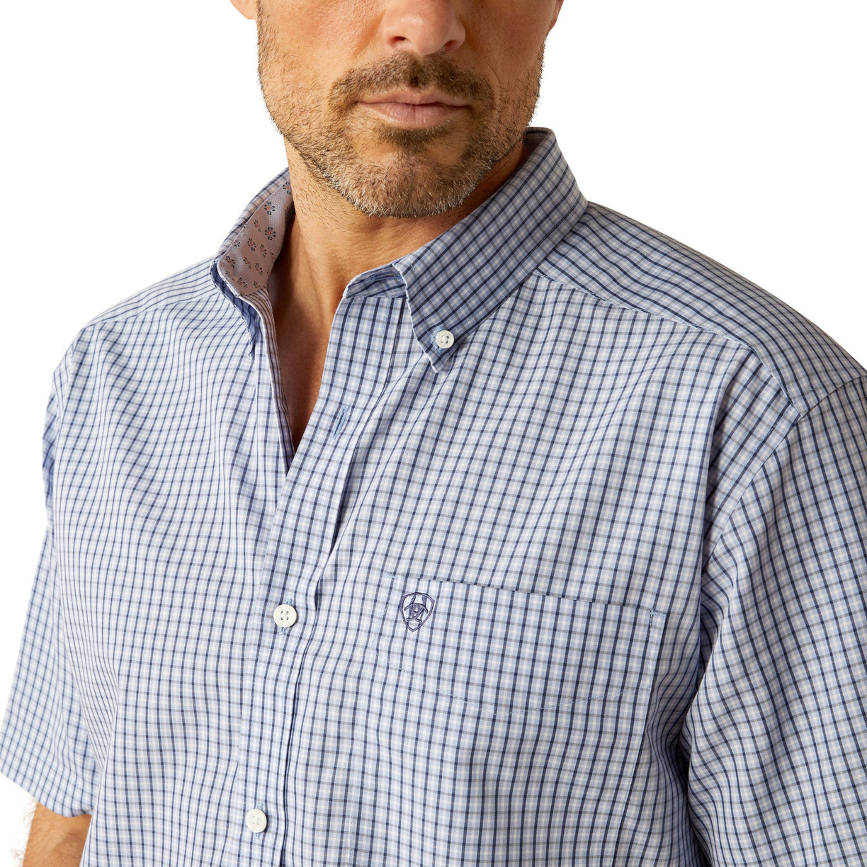 Man wearing a checkered shirt, jeans, and a cowboy hat on a white background