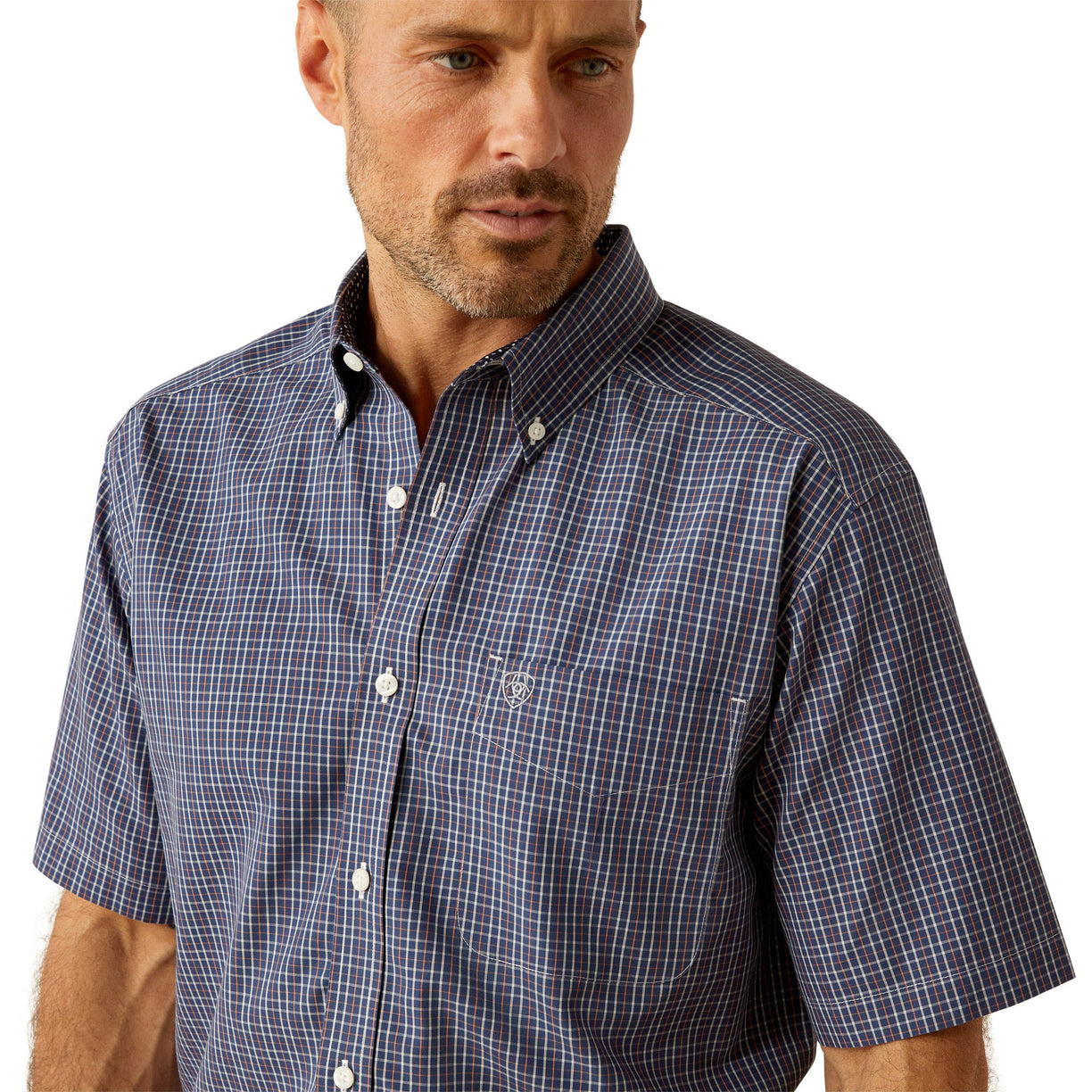 Man wearing a checkered short-sleeve shirt and dark pants on a white background