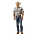 Man wearing a plaid shirt, jeans, and a cowboy hat on a white background