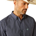Man wearing a checkered shirt, jeans, and a cowboy hat on a white background