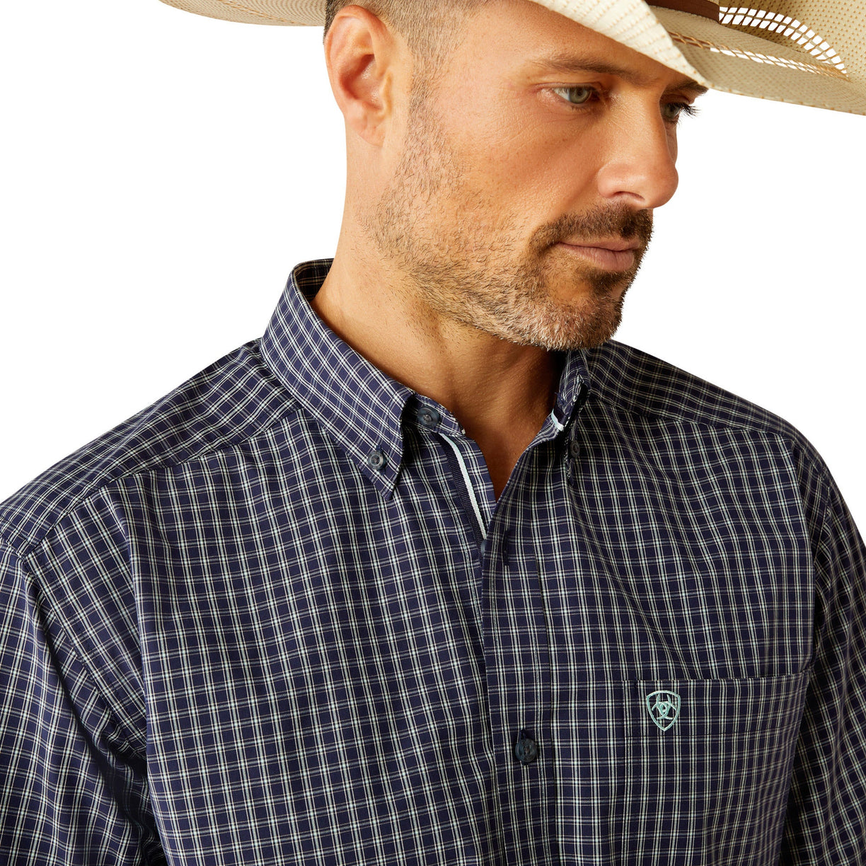 Man wearing a checkered shirt, jeans, and a cowboy hat on a white background