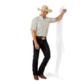 Man wearing a plaid shirt, cowboy hat, and jeans on a white background