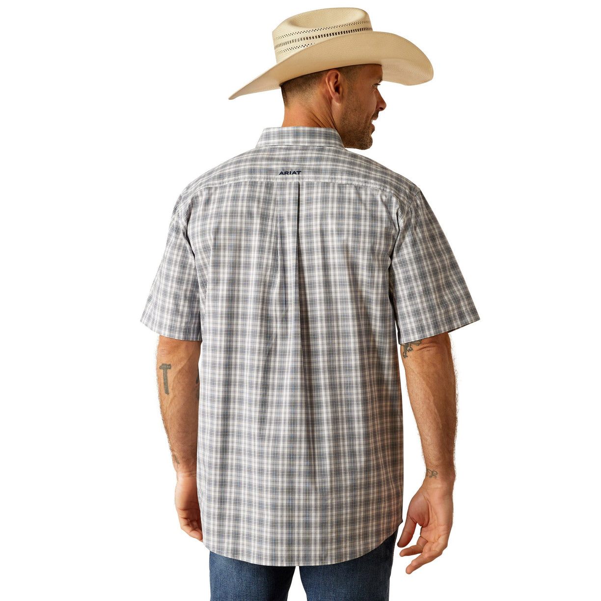 Man wearing a plaid shirt, jeans, and a cowboy hat on a white background