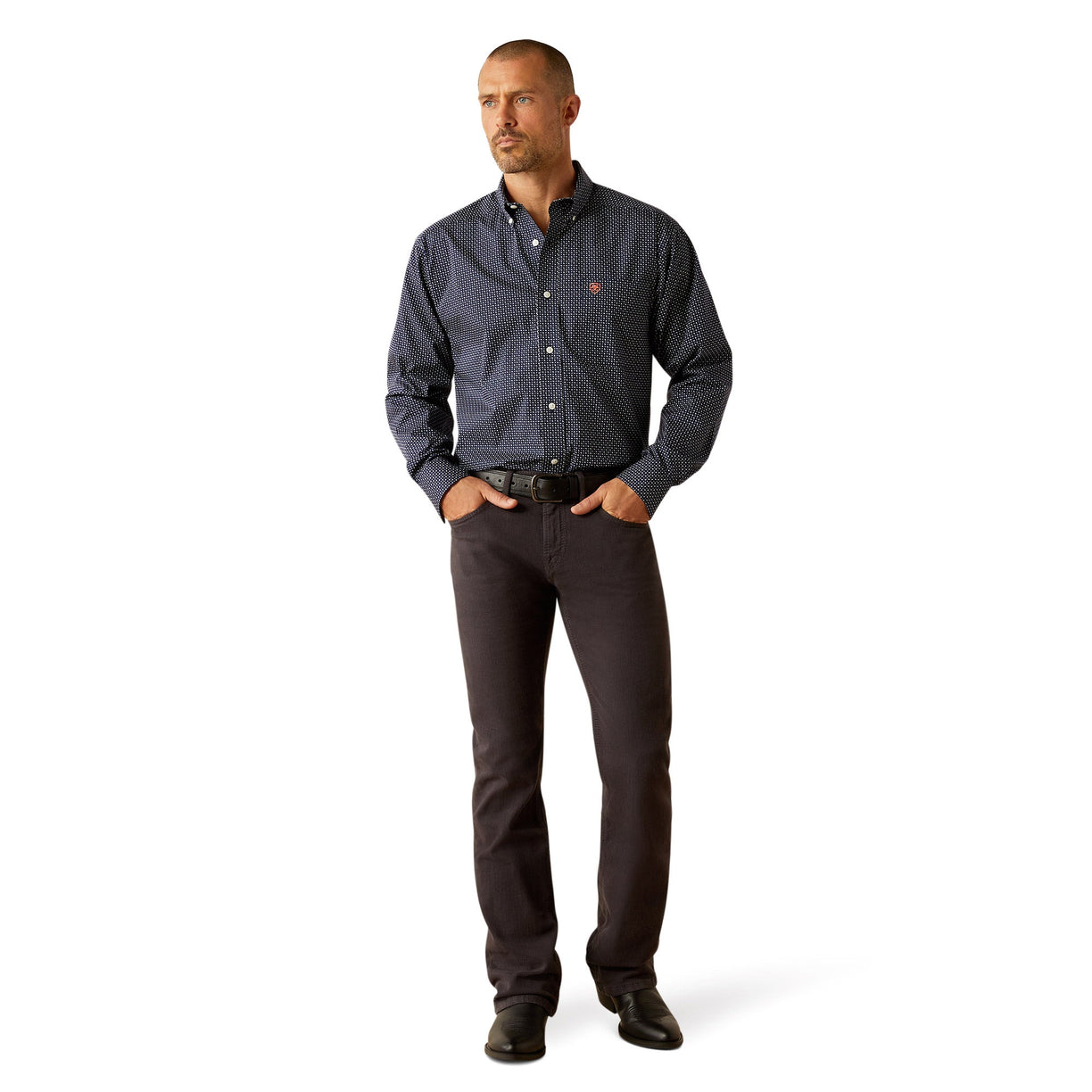 Man wearing a patterned dark shirt and dark pants on a white background