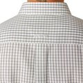 Man wearing a checkered shirt and jeans on a white background