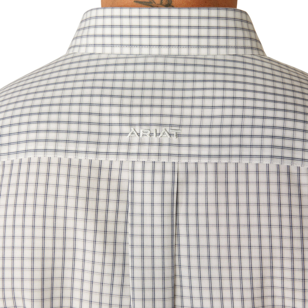 Man wearing a checkered shirt and jeans on a white background