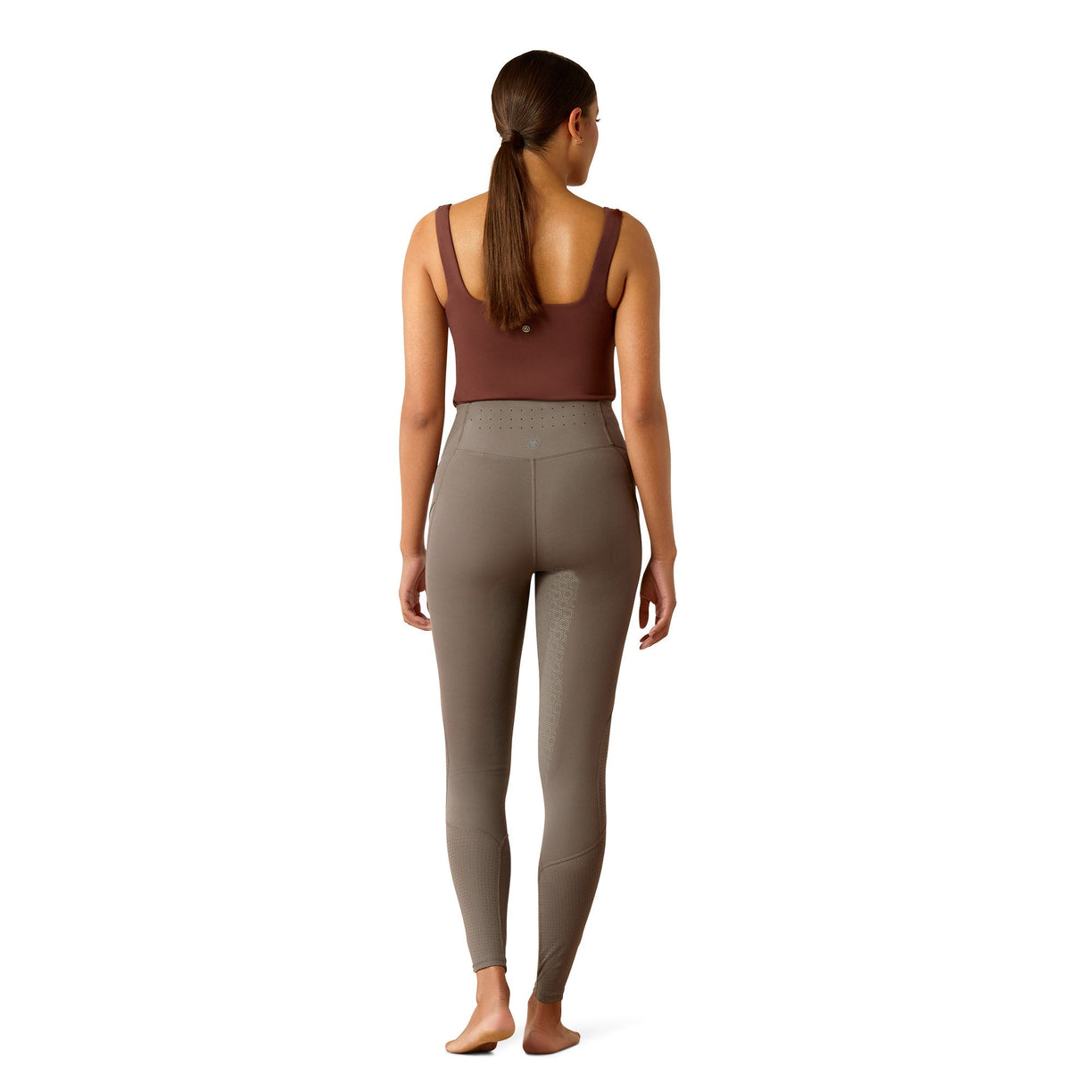 Brown leggings worn by a person on a white background