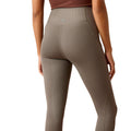 Brown leggings worn by a person on a white background
