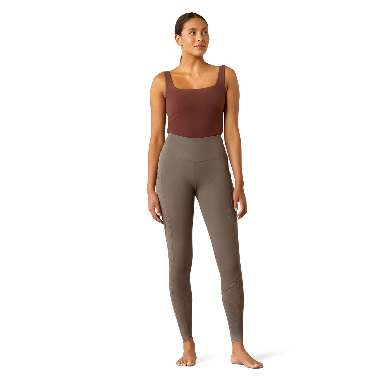 Brown leggings worn by a person on a white background