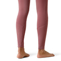 Pink leggings worn by a person on a white background