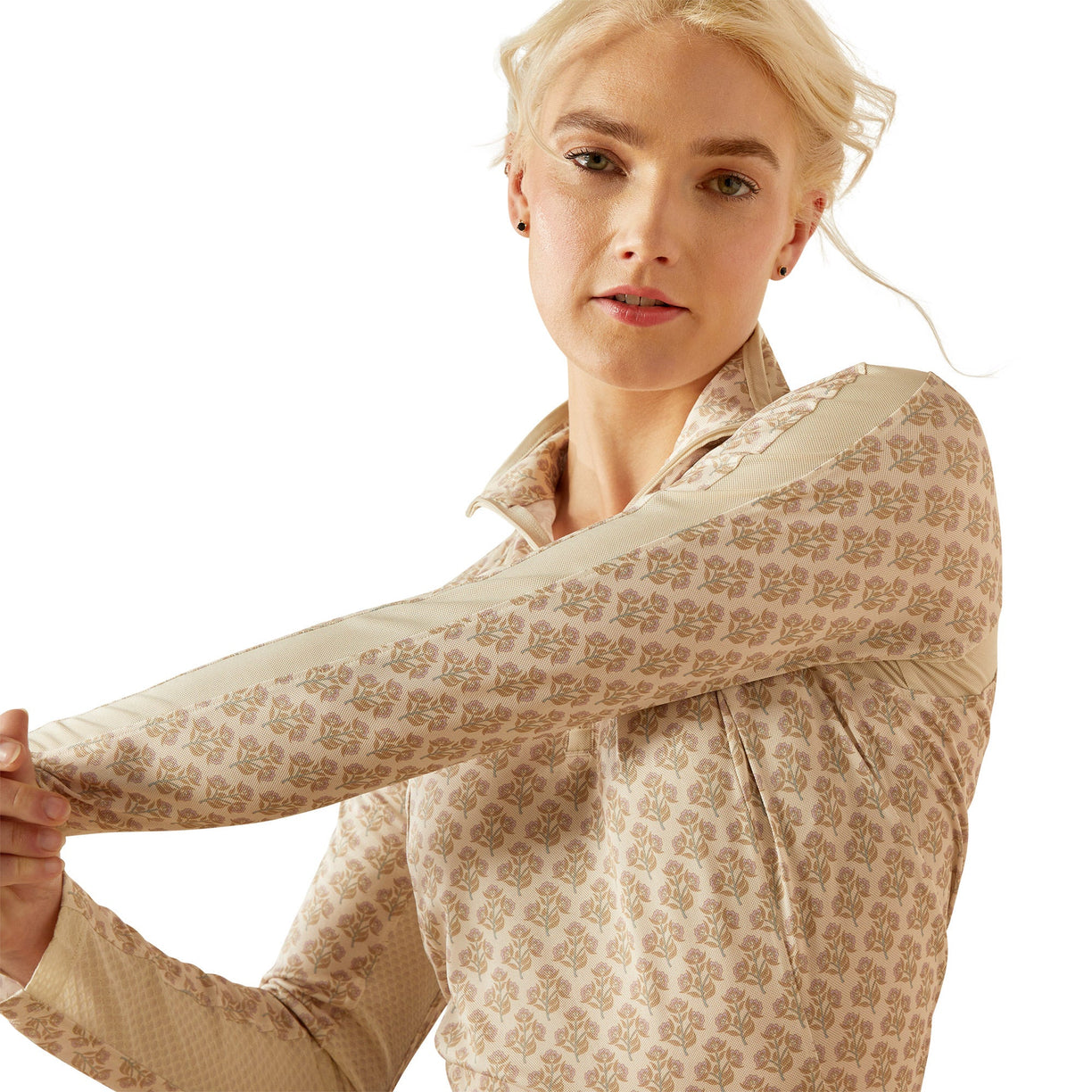 Woman wearing a beige equestrian outfit on a white background