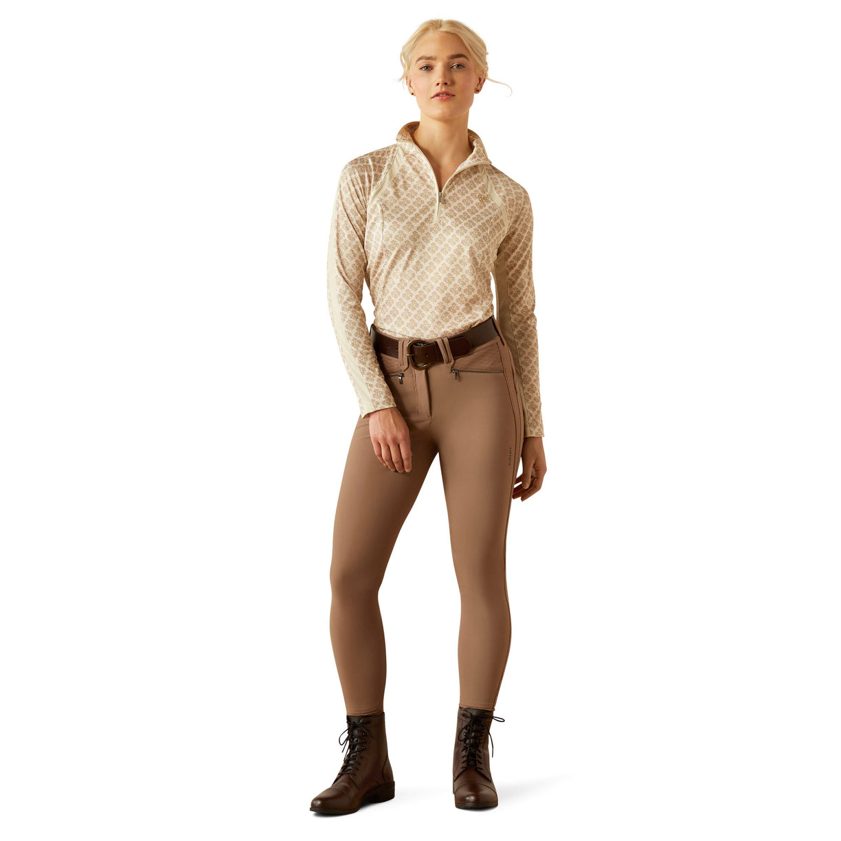 Woman wearing a beige equestrian outfit on a white background