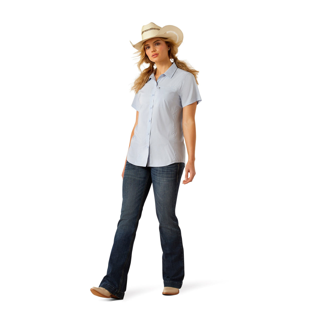 Woman wearing a light blue button-up shirt, jeans on a white background