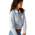 Woman wearing a light blue shirt and jeans on a white background