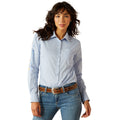 Woman wearing a light blue shirt and jeans on a white background