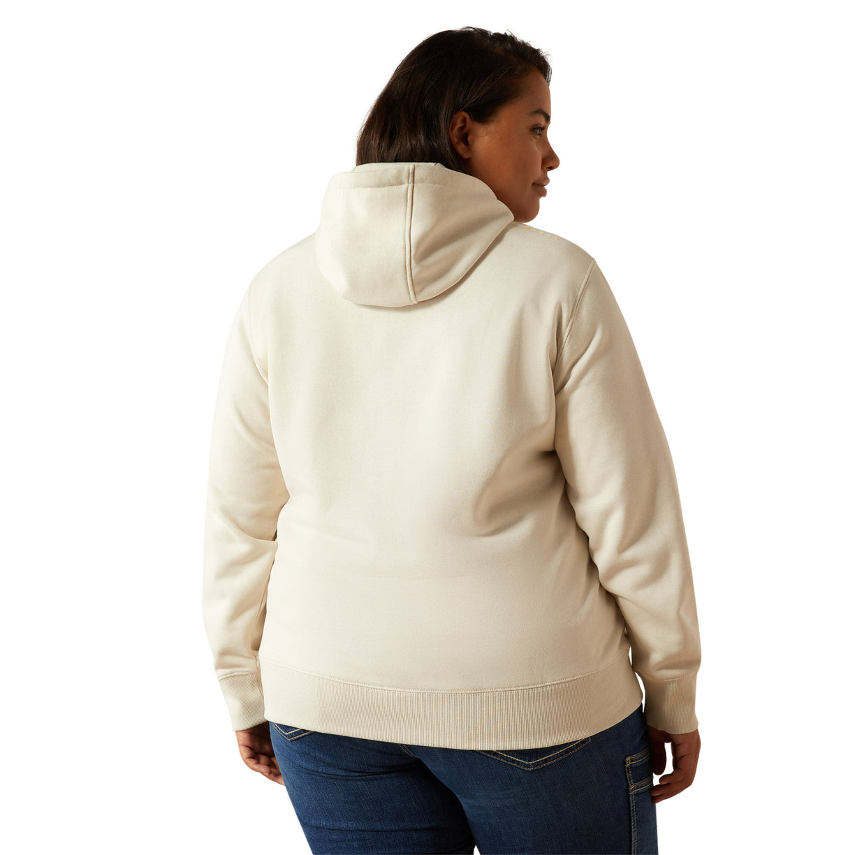 Woman wearing a beige hoodie with Ariat brand logo on a white background