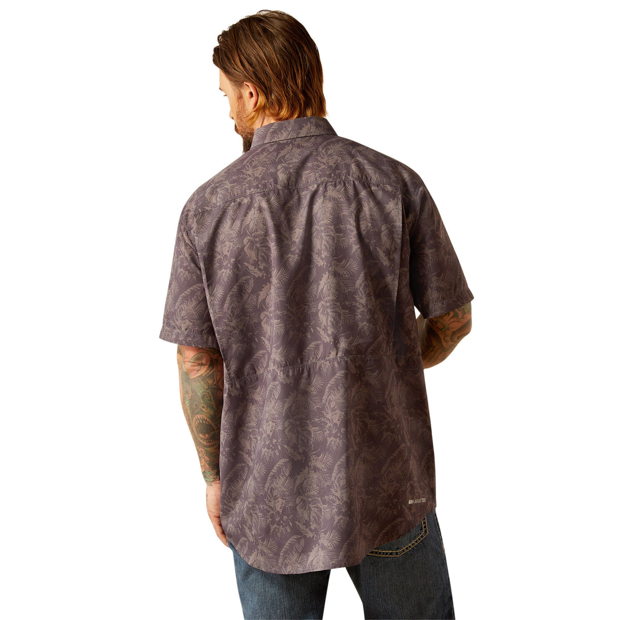 Man wearing a brown patterned shirt with a white background