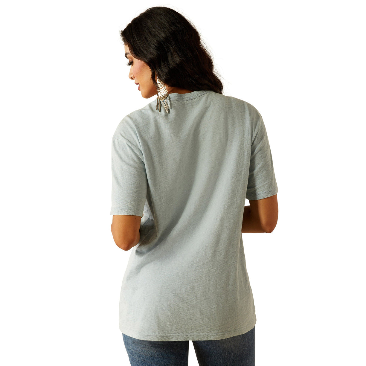 Woman wearing a gray t-shirt with a graphic design on a white background