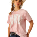 Woman wearing a pink t-shirt with white text, denim shorts, and a cowboy hat on a white background
