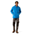 Man wearing a blue hoodie with Ariat brand logo on a white background