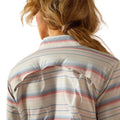 Woman wearing a striped shirt and jeans on a white background