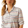 Woman wearing a striped shirt and jeans on a white background