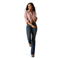 Woman wearing a pink plaid shirt, blue jeans, and a cowboy hat on a white background