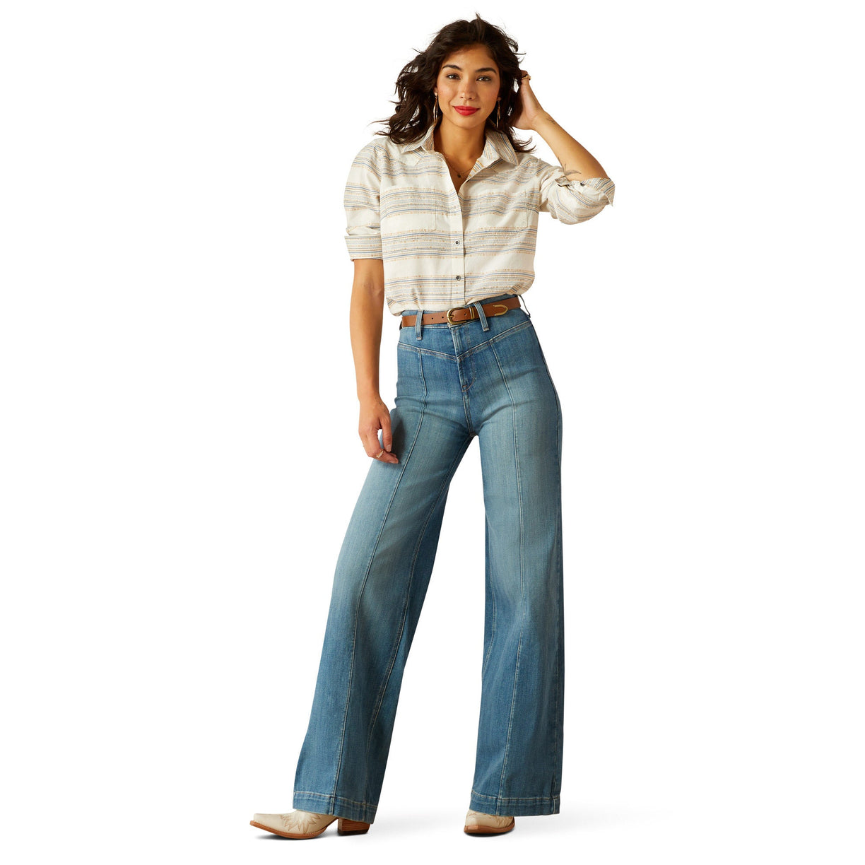 Woman wearing a plaid shirt and blue jeans on a white background