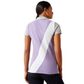 Woman wearing a purple and white striped polo shirt with 'Ariat' branding on a white background