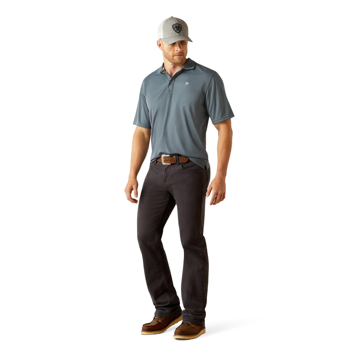 Man wearing a blue gray polo shirt with Ariat branding and cap on a white background