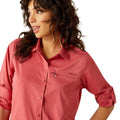 Woman wearing a red shirt and blue jeans on a white background